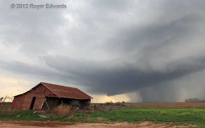 Young Supercell behind Abandoned Farmhouse