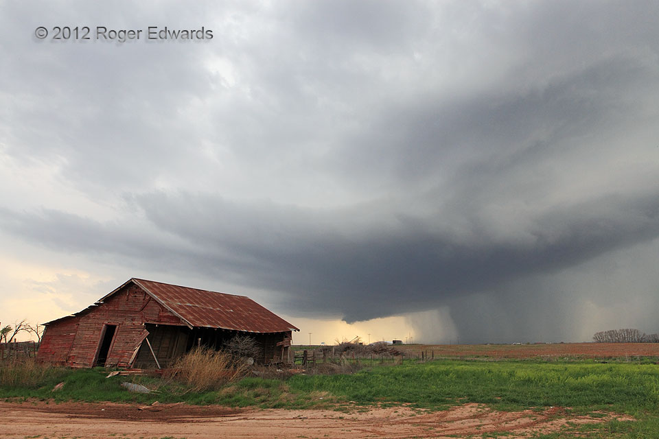 Young Supercell behind Abandoned Farmhouse